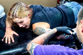 Jake Bertelsen works on a tattoo on Andrea Briggs on June 25, 2015. Justin Franz | Flathead Beacon