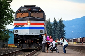 Jayme Miller takes a photo of John and Kerry Loewen in front of the Amtrak Exhibit Train that was on display in Whitefish on Aug. 15 and 16. The five-car train is led by an histoic diesel locomotive and features aritacts from Amtrak's 44-year history. The train travels the country and makes stops like this one about two dozen times a year. Amtrak spokesperson Rob Eaton said the railroad wanted to bring the train to Whitefish this summer to thank the community for supporting the Empire Builder. "We want to reinforce our commitment to this community," he said. Justin Franz | Flathead Beacon.